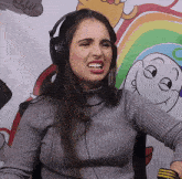 a woman wearing headphones is making a face