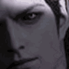 a close up of a man 's face with a blurred background