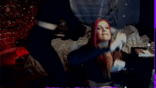 two women with purple hair are standing next to each other on a bed