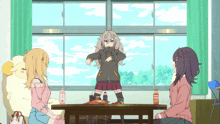 a bottle of orange juice sits on a table with two girls