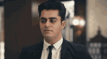 a man in a suit and tie is making a funny face