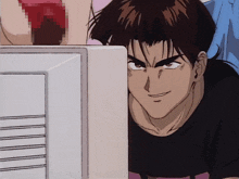 a man in a black shirt is looking at a monitor