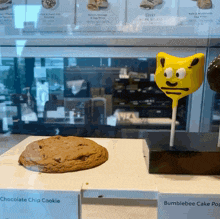 a chocolate chip cookie and a bumblebee cake pop