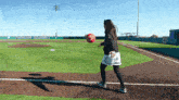 a baseball field with the word softball on the wall behind it