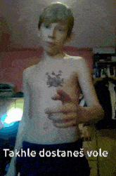 a shirtless boy has a tattoo on his chest and the text takhle dostanes vole