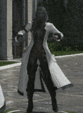 a woman in a white coat and black boots stands on a sidewalk