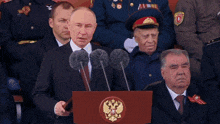 a man stands at a podium with ura written on it