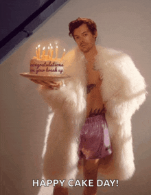 a man in a fur coat is holding a cake that says congratulations on your break up on it