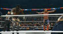 two wrestlers are in a ring with a crowd watching and a sign that says aew on it