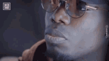 a close up of a man 's face with glasses and a soccer stories logo in the corner