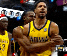 basketball player wearing a yellow jersey that says indiana on the front