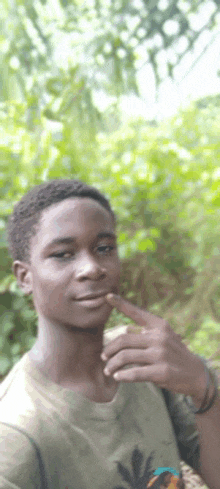 a young man is taking a selfie with his finger on his chin