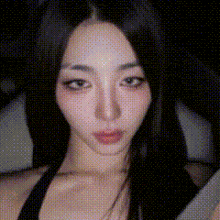 a close up of a woman 's face with a black background