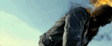 a man is flying through the air with a flame coming out of his pants .
