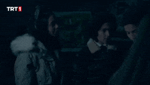 a group of children are standing in a dark room with trt1 written on the bottom