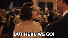 a woman says but here we go in a crowded room