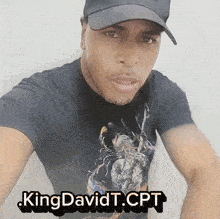 a man wearing a hat and a t-shirt that says kingdavidt.cpt