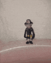 a small figurine of a fireman is standing on a pink sink