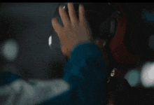 a person wearing headphones with the letter t on the bottom