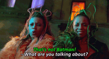 two women are standing next to each other and one says " that 's not batman what are you talking about ? "