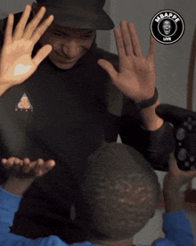 a man wearing a black shirt that says mbappe live
