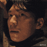 a close up of a man 's face with the word netflix on the bottom right