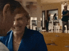 a man and a woman are laughing in a living room .