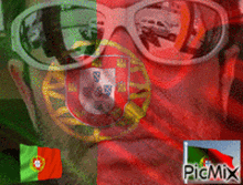 a man wearing sunglasses with a portuguese flag on his face
