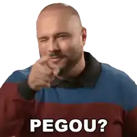 a bald man with a beard is pointing at the camera with the word pegou below him