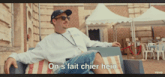 a man sits on a couch with the words " on s fait chier hein " written below him