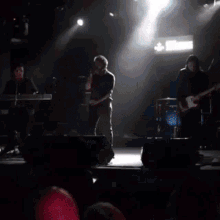a group of people playing instruments on a stage