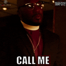 a man in a suit says call me in a trap city ad