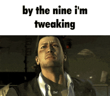 a man in a suit with the words by the nine i 'm tweaking written above him