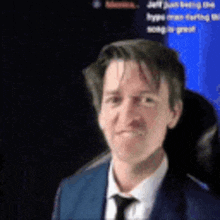 a man wearing a suit and tie is looking at the camera .