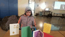a boy sits at a table with a card that says happy birthday on it