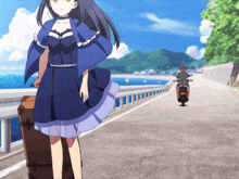 a girl in a blue dress is walking down a road with a suitcase and a man on a scooter