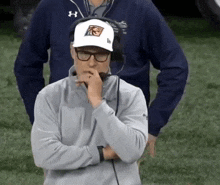 a man wearing a white hat with a tigers logo