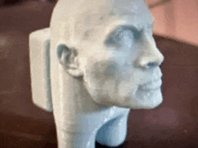 a white statue of a man 's head with a skull on it