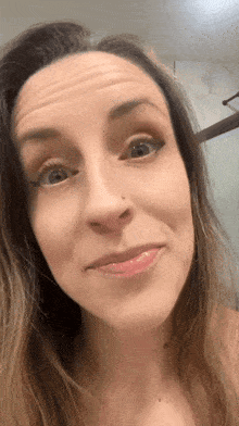 a close up of a woman 's face with a nose piercing
