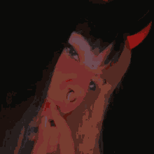 a woman with a nose ring and a red bow on her head