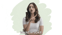 a woman in a white shirt is pointing her finger and says what a joke .