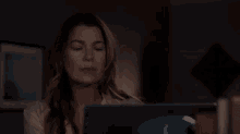 a person 's hands typing on a laptop keyboard
