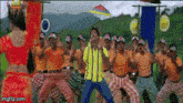 a man in a yellow shirt is surrounded by a group of men in orange shirts
