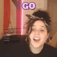 a woman wearing a bandana and a hat with the word go above her head