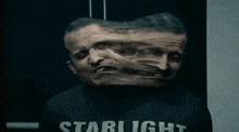 a man wearing a starlight shirt is screaming with his mouth open