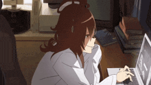 a woman in a white coat is typing on a laptop computer
