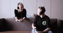 a man and a woman wearing headphones are playing a video game together .