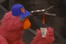 a sesame street character is holding a card of ron darling