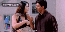 a man and a woman are standing next to each other and talking to each other .