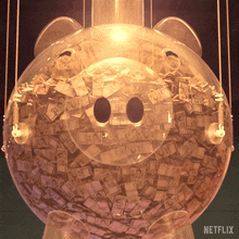 a clear piggy bank filled with money with a netflix logo on the bottom